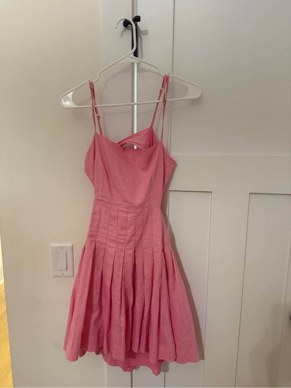 pink open back dress with pleats on the front